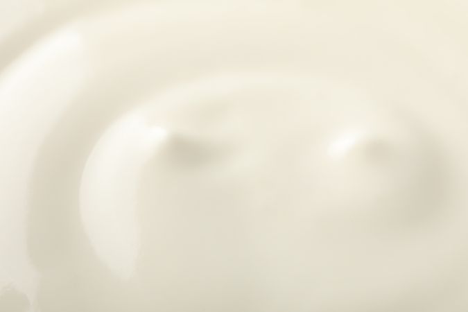 Cream yogurt as background, closeup and space for text