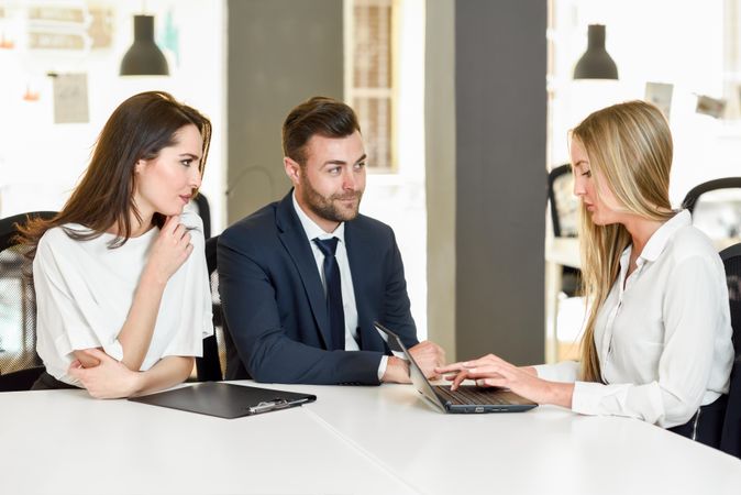 Three colleagues working together in stylish office