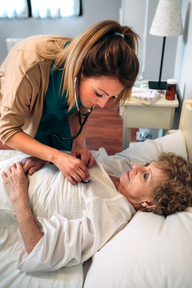 Caregiver auscultating woman