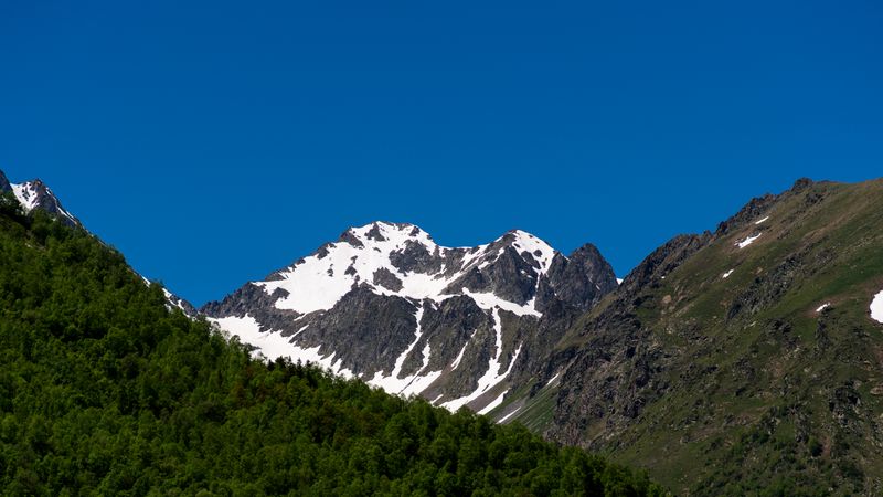 Mountainous landscape with snow patches