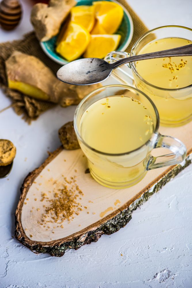 Ginger detox drinks on wooden tray
