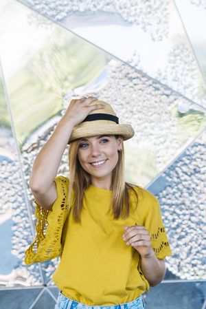 Stylish woman posing in straw hat