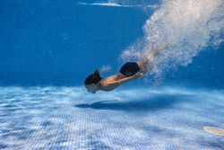 Carefree boy swimming in pool