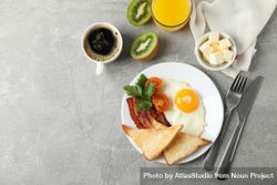 Top view of breakfast for one with eggs, toast, bacon and coffee, copy space 5rjY35