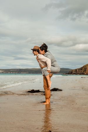 Happy couple having fun on Scottish coast