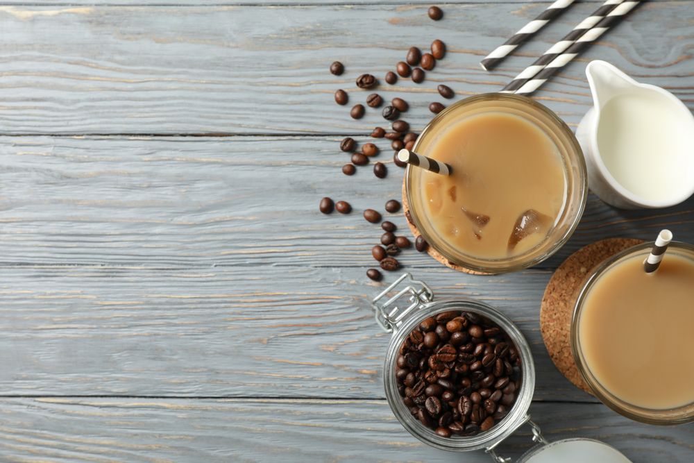 Composition with glasses of ice coffee on wooden background
