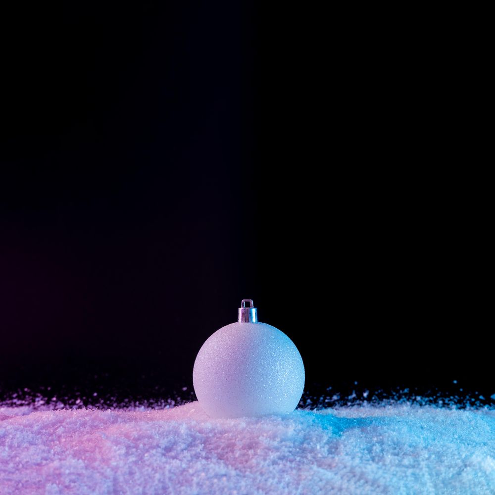 Bauble on vibrant bold gradient holographic colors on snow