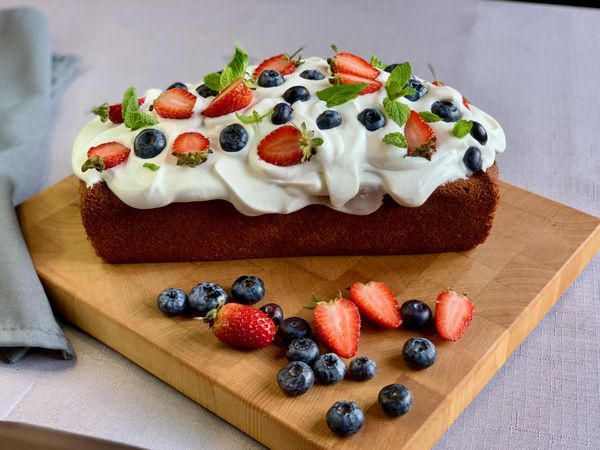 Strawberry and blueberry muffin topped with buttercream