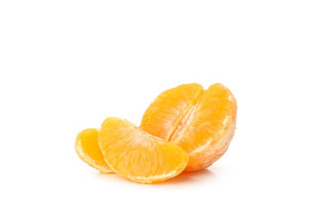Half of mandarin and pieces isolated on light background