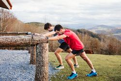 Sportsmen stretching after running in mountains