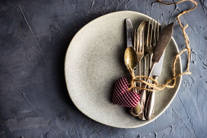 St. Valentine day table setting with felt hearts, string and cutlery, with copy space