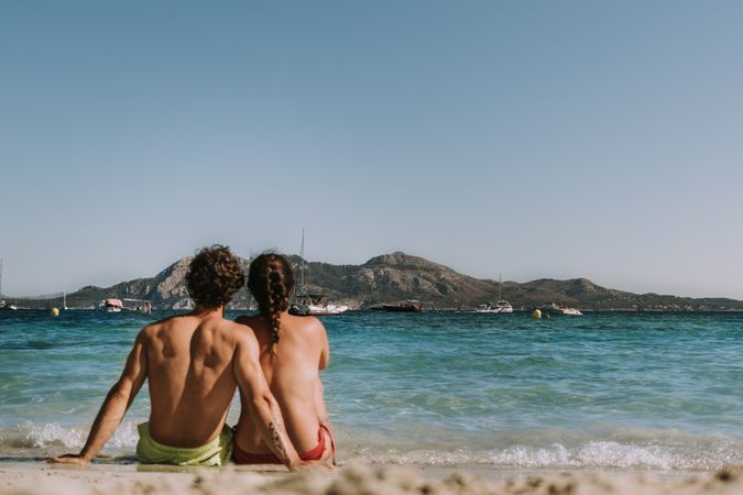 Happy couple hugging by sea