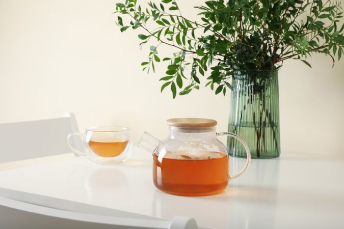 kitchen table with tea and plant in bright room