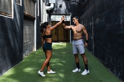 Sportive Hispanic couple giving high five