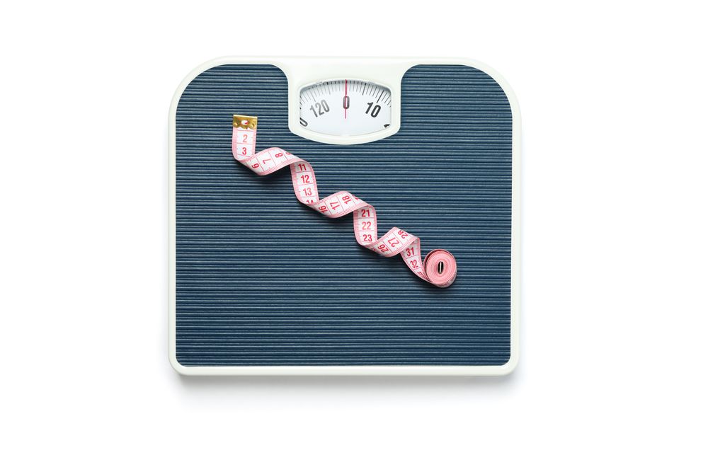 Weigh scales and measuring tape isolated on blank background