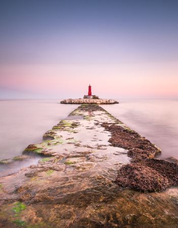 Rough path to islet with lighthouse