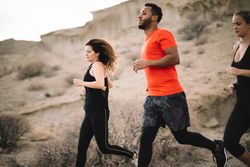 Multiracial friends jogging on nature together