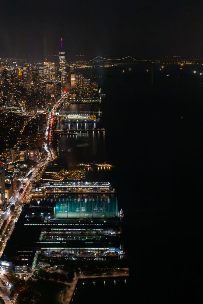 Aerial View of New York City. Helicopter Photo of a Big City with Skyscrapers Next to Port Area in New York City. Panoramic View with Highway Traffic