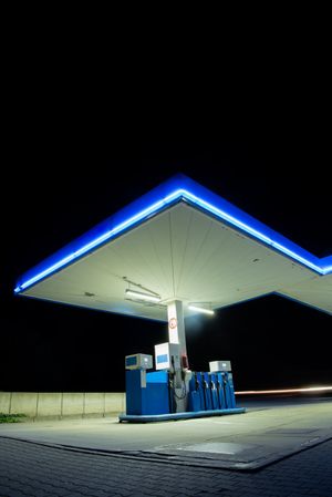 Fuel station with neon lights on the road side in a german village, night photo