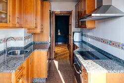 Kitchen on two fronts with wooden furniture