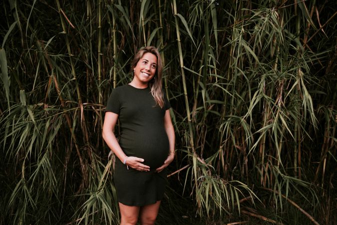 Pregnant woman standing in garden