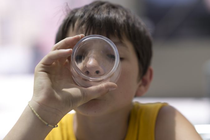 Male child drinking a glass of pure water