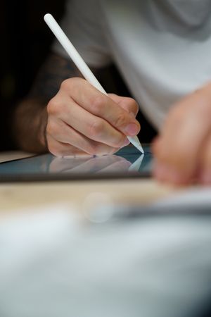A young artist creating illustrations on a digital tablet
