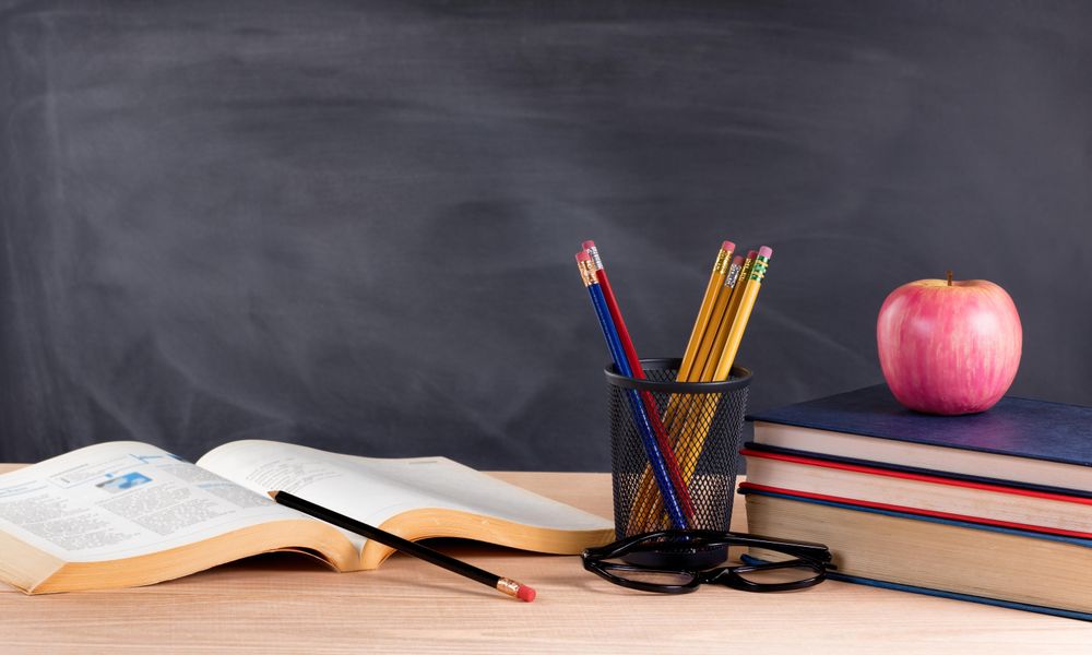 Desk in classroom ready to learn from textbooks