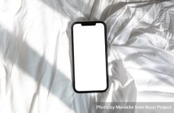 Top view of phone mock up on bed sheet 5alza0