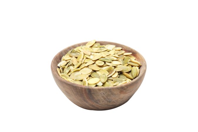 Fall season food - pumpkin seeds, isolated on blank background