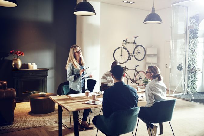 Woman leading discussion with colleagues in bright office