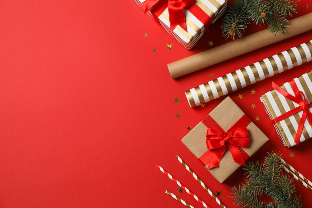 Composition with Christmas accessories on red background, space for text