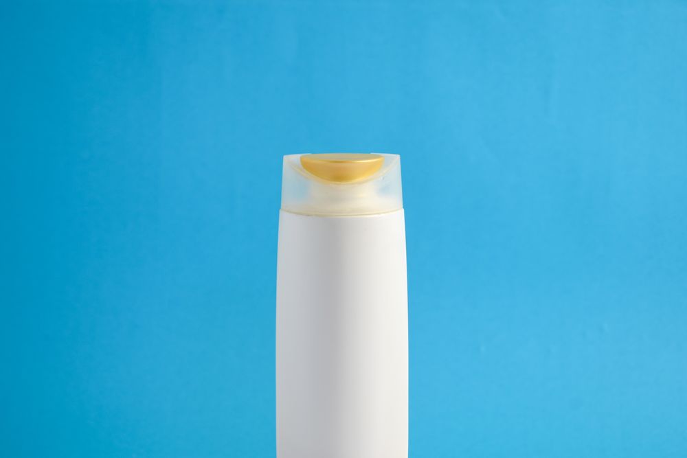 Body wash bottle with no labels with blue background