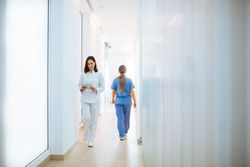 Doctor in white uniform walking along corridor