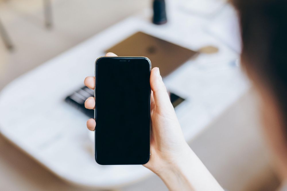 Cropped image of hand holding a cellphone