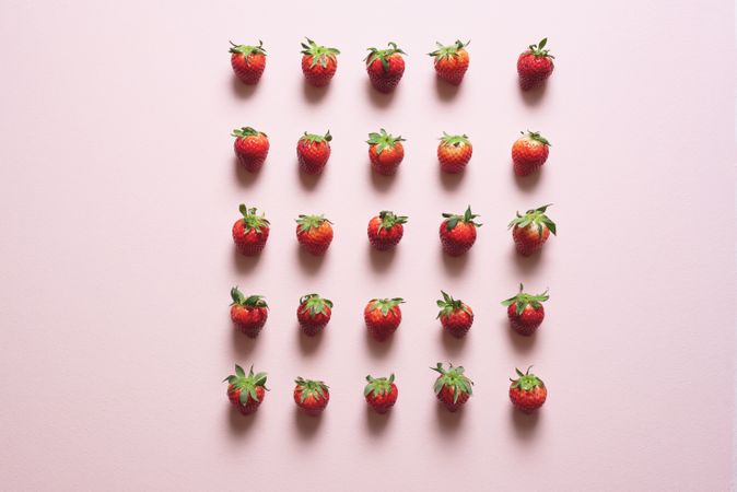 Fresh strawberries symmetrically aligned on the table