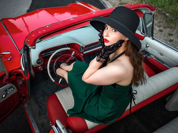Old-timer red Cadillac and a young woman