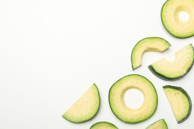 Flat lay with avocado slices on plain background, top view