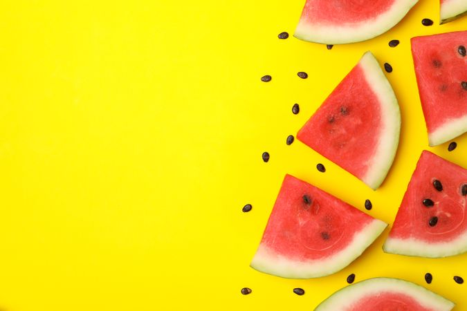 Composition with watermelon slices on yellow background, top view