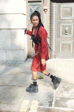 London, England, United Kingdom - September 15th, 2019: Woman in red with chunky trainers