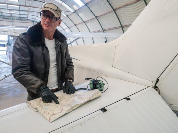 Pilot with map on small plane