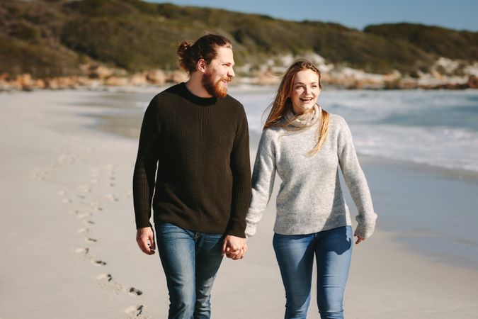 Smiling couple walking on beach