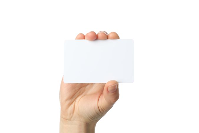Female hand holding blank business card, isolated on plain background
