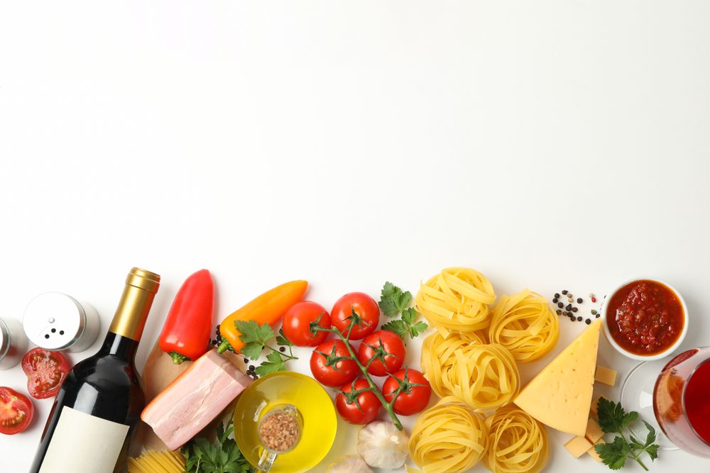 Composition with pasta and ingredients for cooking on plain background, top view
