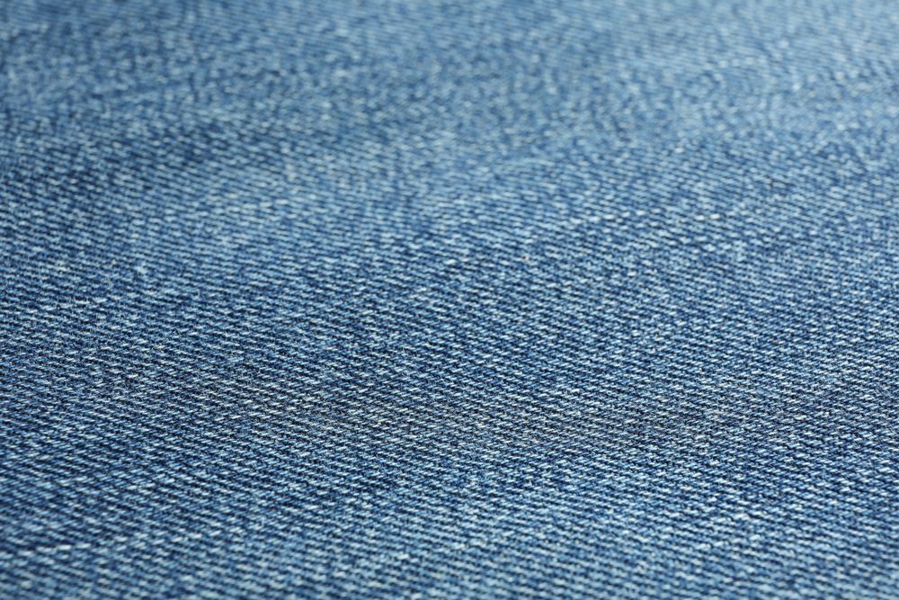 Texture of blue jeans as background, space for text