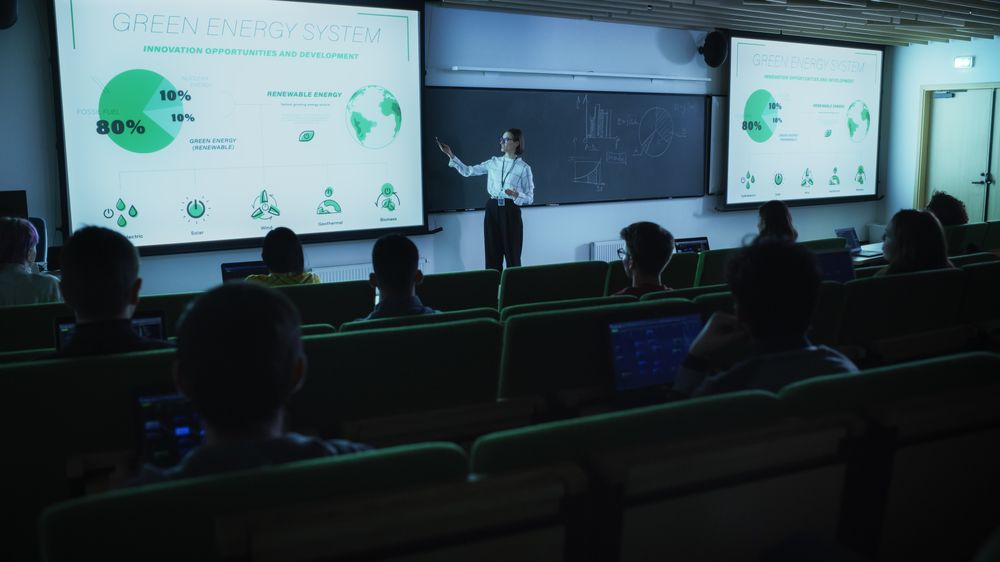 Young Postgraduate PhD Student Giving a Renewable Energy Lecture to Diverse Multiethnic Group of Women and Male Scholars
