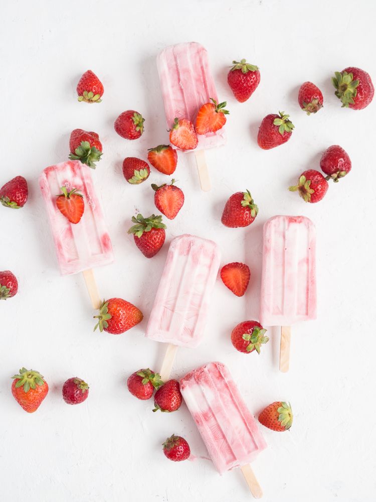 Pink popsicles and fresh strawberries