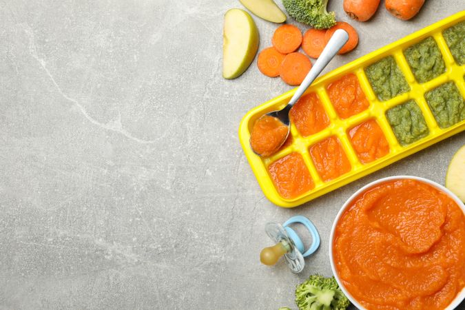 Composition with baby food on gray background, top view