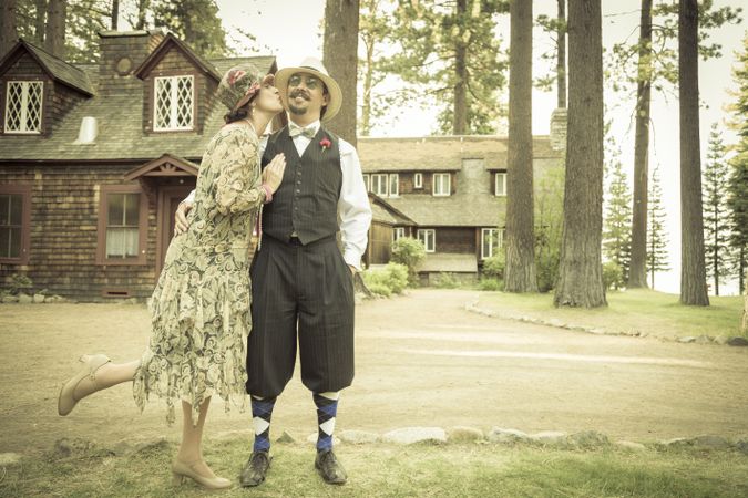 Affectionate Dressed Romantic Couple in Front of Old Cabin
