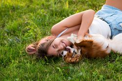 Teen girl lying with the dog